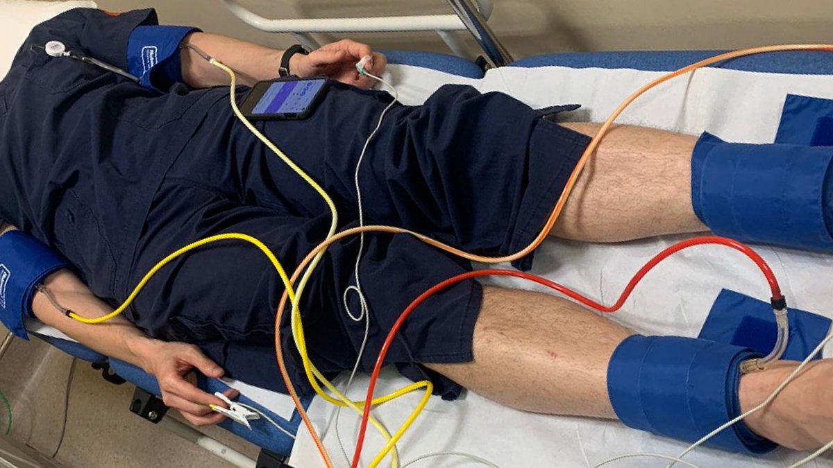 Ankle-brachial index test measuring blood pressure on a patient's arm and ankle