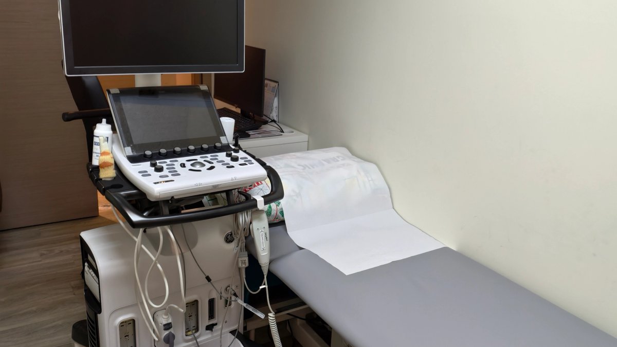 Cardiologist performing an echocardiogram ultrasound on a patient