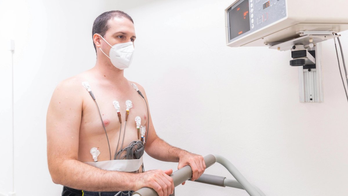 Patient undergoing an exercise treadmill stress test while monitored by a doctor